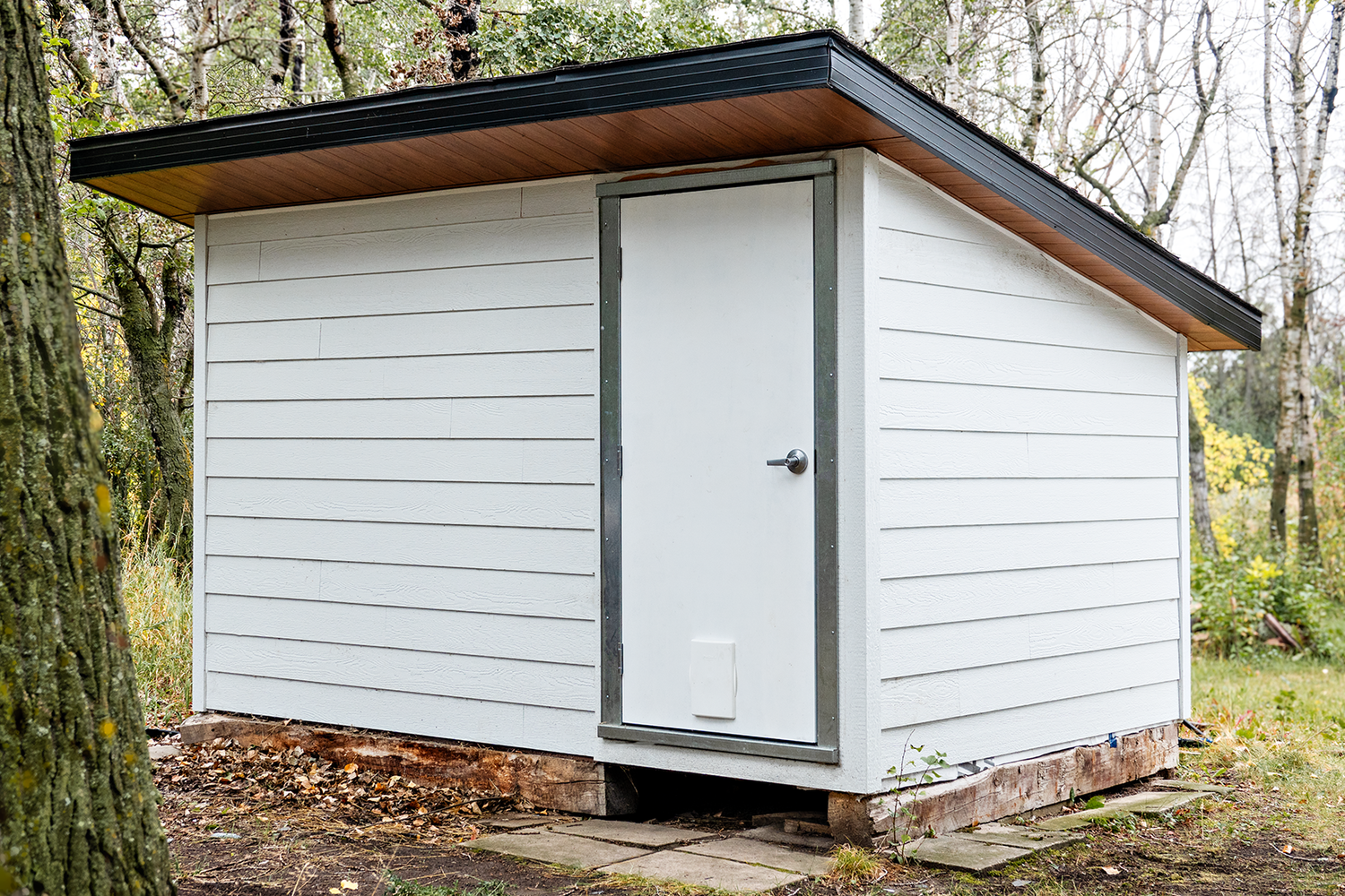 Man door and fame installed on shipping container turned into shed