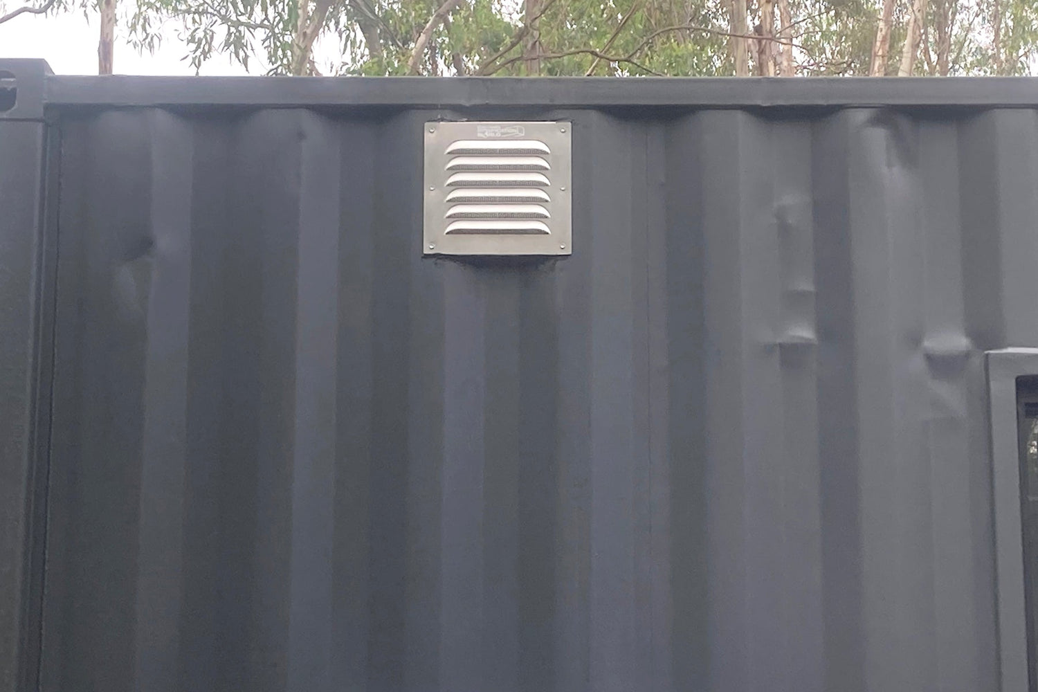BigAir30 louvered vent installed on side wall of shipping container between corrugations