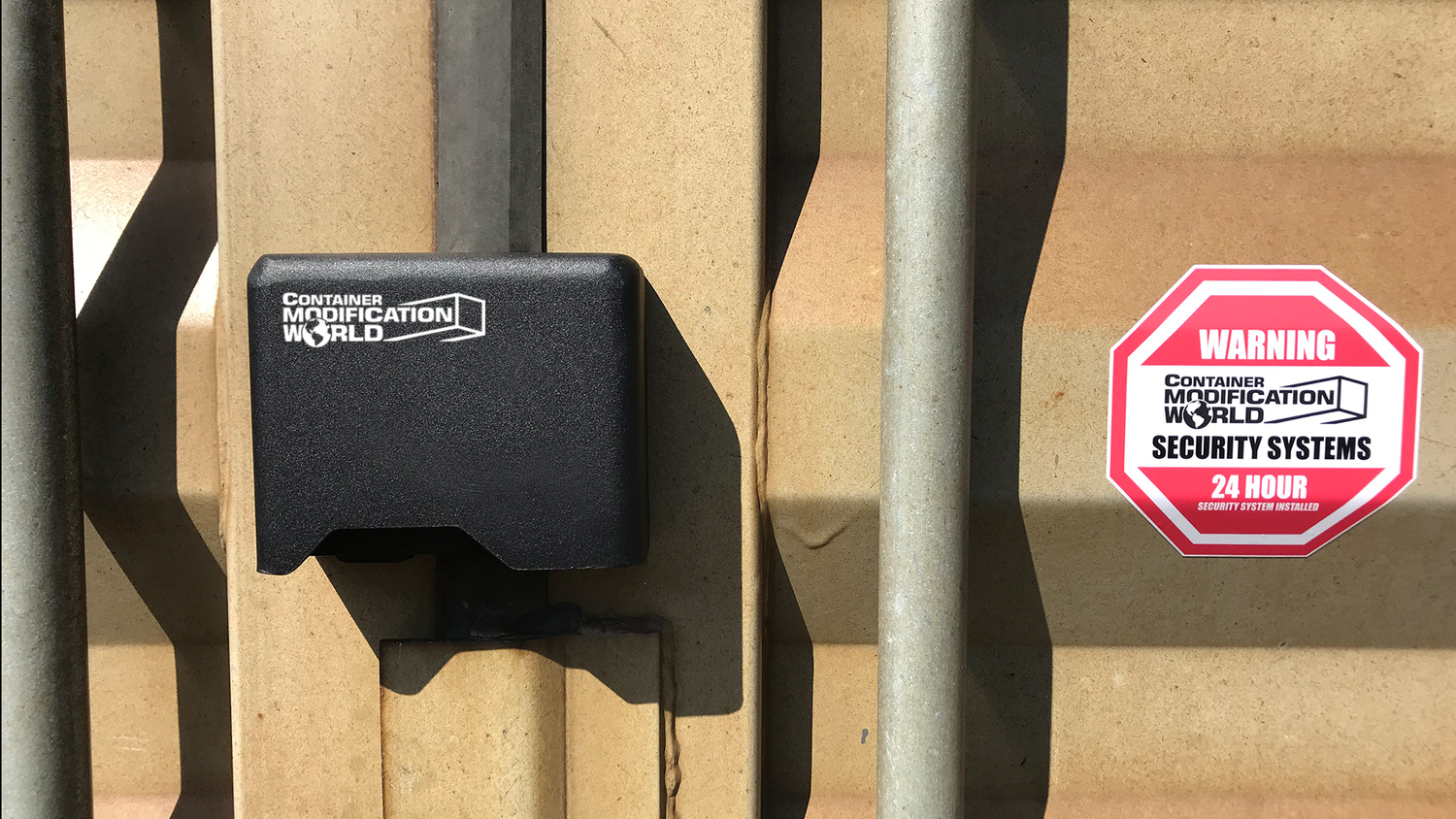 Right-hand container lock box securely mounted on shipping container door, shown alongside a red warning security decal from Container Modification World.