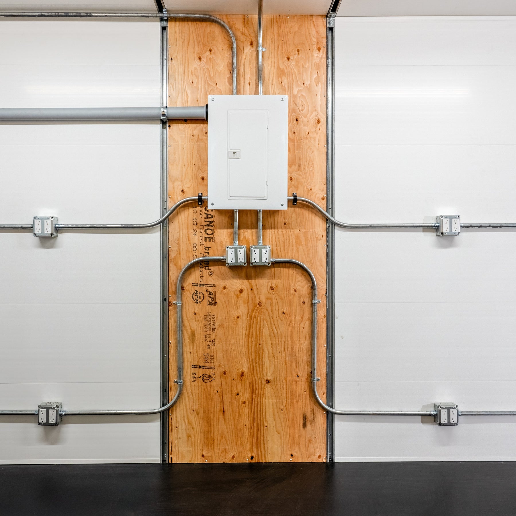 20 foot GLO ground level office site shack electrical panel and conduit wall