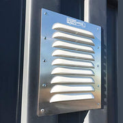 Installed BigAir Louvered Container Vent on a shipping container sidewall, showcasing its durable aluminum frame and angled louvers for airflow and moisture control.