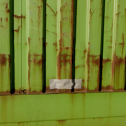Quick patch installed on side of shipping container to repair a hole