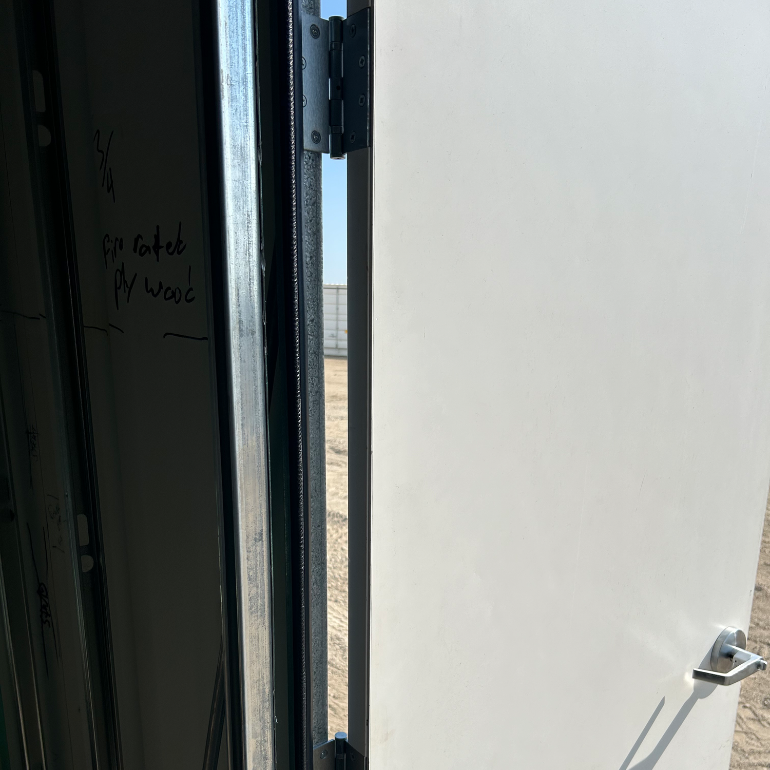 close up of hinges installed in frame attaching to the door 
