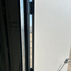 close up of hinges installed in frame attaching to the door 